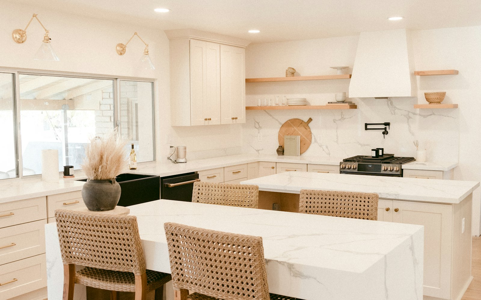 Contractor reviewing renovation blueprints with a homeowner inside a bright luxury residential home